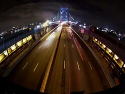 Night time, time lapse, wide angle of Philadelphia cityscape, overhead shot traffic crosses the Ben Franklin Bridge. Stock Footage