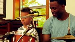 MS Father teaching young son to play drums Stock Footage