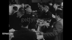 1937: WS EXT hotel Savannah w/ traffic moving FG. INT Hotel meeting room w/ Dr. Herty saying, SOT asking them to stand by him financially, he can make high quality white paper out of pine, could mean new era for beloved southland. The Great Depression Instructional Video