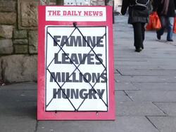 Newspaper Headline Board - Famine leaves millions hungry Stock Footage