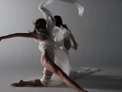 two woman draped with silk around them dancing Stock Footage