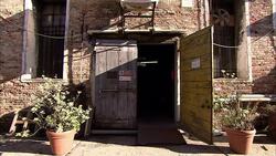 A ramp leads to the open doorway of a brick building. Stock Footage