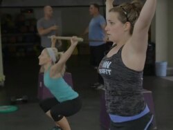 Tali performs dowl squats; Carly in background. Stock Footage