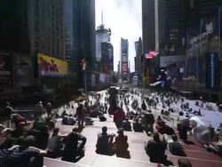 WS TU T/L Shot of People sitting in front of blinking billboard at Times Square / New York, USA Stock Footage