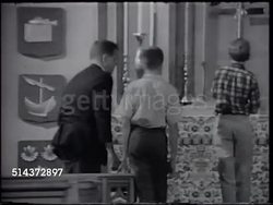 1966: STARK DILLARD: VS Reverend Stark in church w/ altar boys practicing lighting candles, [VO Not a glamorous job], boys putting candles out, SOT Stark explaining to them what not to do in front of congregation, if need help ask, don't suffer. Instructional Video