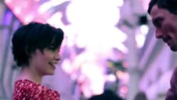 Young couple dance and spin under the changing colors of Fremont Street Stock Footage