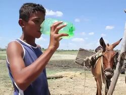 MS TS Shot of Kid drinking water from shaft / Pilao Arcado, Bahia, Brazil Stock Footage