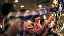 Guy learns how to play slots with friends in Las Vegas casino Stock Footage