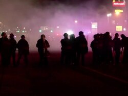 Car on fire in Ferguson following Darren Wilson jury decision Stock Footage