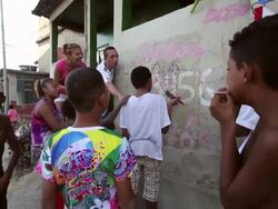 A Group Of Local Children Paint Fuleco The FIFA 2014 World Cup Mascot On A Wall Stock Footage