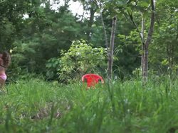 MS Little girl jumps to pick limes from lime tree in meadow / Cobano, Puntarenas, Costa Rica Stock Footage