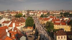 Pedestrians walk through Prague's Old Town and across the Charles Bridge. Stock Footage