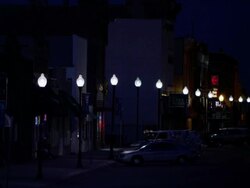 Static view of a street at night while a car drives by. Stock Footage