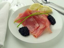 Smoked salmon & caviar rotate on a white plate with lemon & dill Stock Footage