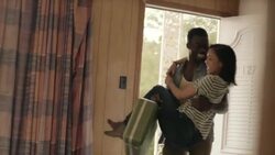 Young man carries young woman into motel room and falls onto bed with her Stock Footage