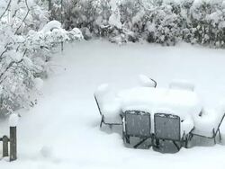 WS Heavy snow layer on furniture of garden at heavy snowfall / Saarburg, Rhineland-Palatinate, Germany Stock Footage