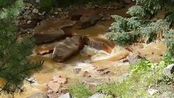 Orange mining river water pollution North Clear Creek Colorado Mountains Stock Footage