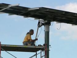 WS ZO Technician wiring together photovoltaic array with energy efficient house / Grass Lake, Michigan, USA    Stock Footage