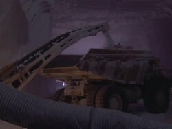MS Conveyor loading salt into truck underground in salt mine / Sicily, Italy Stock Footage