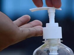 Hand pushing top of liquid soap dispenser Stock Footage