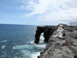 WS Shot of waves crashing again Holei Sea Arch in Volcanoes National Park on sunny day / Volcano, Hawaii, Big Island, United States Stock Footage