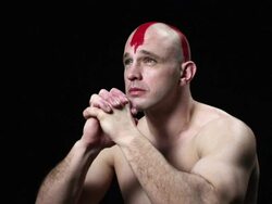 Man with red cross painted on his head, hands clasped Stock Footage