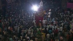 A crowd follows a Diwali procession through a street in India. Stock Footage