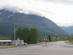 WS View of Haines Highway of start of Alaska Highway at Haines Junction and cloud capped mountains in back side / Haines Junction, Yukon, Canada Stock Footage