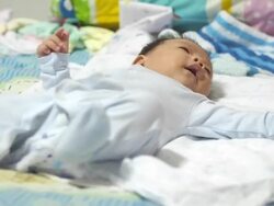 Baby lying on bed Stock Footage