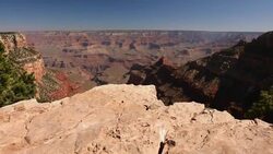 Scenic overlook of Grand Canyon from the rim looking down to the deep valley below Stock Footage
