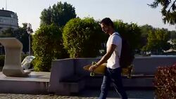 Man with longboard walking Stock Footage