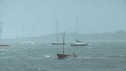 Sailboats battened down for an impending storm bob around in the storm swell. Stock Footage