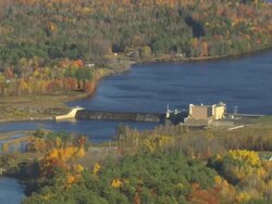 WS AERIAL ZI TS View of small dam with wooded area at Howland / Maine, United States Stock Footage
