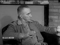 1952: ELKHORN SPORTS: WS Lorraine Hotel on corner of Main Street. INT VS Males sitting in hotel lounge talking about trotting race (horse racing) (SOT). VS Framed photograph of harness race driver Art Shaw. Wisconsin, WI Instructional Video