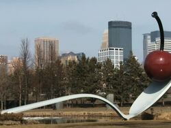 The cherry on the green, located in the Minneapolis sculpture garden, with the city skyline of Minneapolis in the background Stock Footage