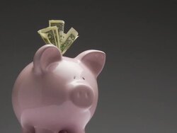 MS, Studio shot of pink piggy bank with one dollar bills rotating Stock Footage