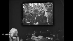 1939: JAPAN PROPAGANDA IN MOVIES: WS 'News' theatre. INT WS Screen of German Nazi footage. Italy's Benito Mussolini talking w/ Adolf Hitler riding in car Nazi salute rally. Instructional Video