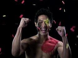 Man with Chinese flag painted on face and chest with ticker tape Stock Footage