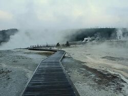 WS View of Steam from hot thermal springs (Biscuit Basin) rising up near sunrise at River Firehole, wooden boardwalk, UNESCO World Heritage Site,Biscuit Basin, Firehole River, Yellowstone National Park, North America / Yellowstone, Wyoming, United States Stock Footage