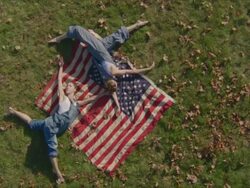 two women dancing with American flags Stock Footage
