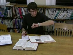 Tired guy takes off glasses and looks at watch Stock Footage