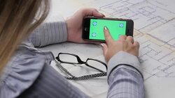 Architect's Hands and Touch Screen Over a Blueprints Stock Footage