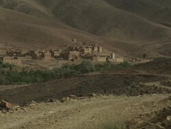 A desolate settlement in the North African mountains, surrounded by scarred land. Stock Footage