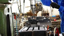 Worker in protective suit working in factory on machinery Stock Footage