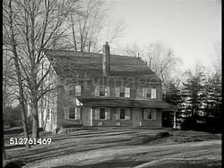 1953: PENNSYLVANIA: LOWER BUCKS COUNTY: Pond on farmland. WS Farmhouse. WS Long open livestock stalls. WS Larger farmhouse w/ wrap-around-porch, boy riding bicycle down path FG. Instructional Video
