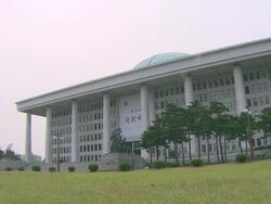 MS T/L Traffic moving in front of National Assembly Building in Yeouido Island / Seoul, South Korea Stock Footage