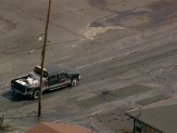 Sept. 10, 2005 aerial truck driving through toxic sludge in wake of Hurricane Katrina / Louisiana Stock Footage
