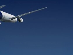 Passenger jet flying over clear blue sky - travel Stock Footage