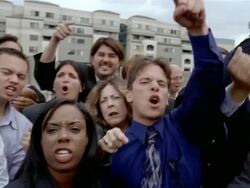 Slow motion medium shot angry crowd glowering and shaking fists at camera Stock Footage