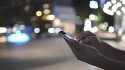 HD:Woman touching smartphone at night time Stock Footage